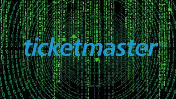 Ticketmaster logo over a dark background with simulated computer code in green text.